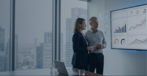 Executivos analisando indicadores fiscais em dashboards corporativos com gráficos em laranja e azul escuro