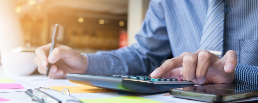 business finance man calculating budget numbers invoices financial adviser working