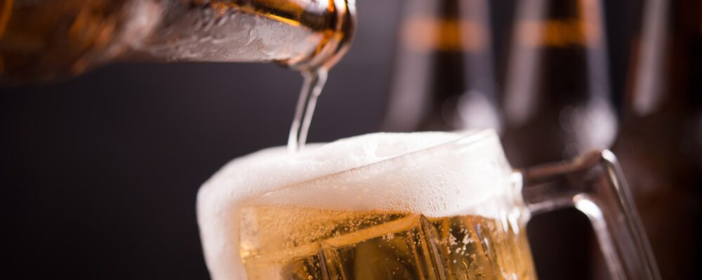 glass bottles beer with glass ice dark background