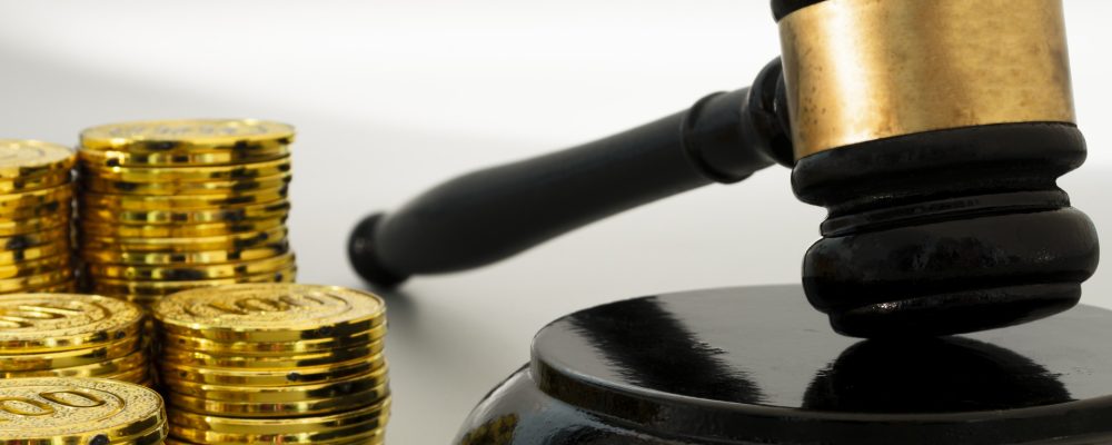 judge gavel with pile gold coins white background