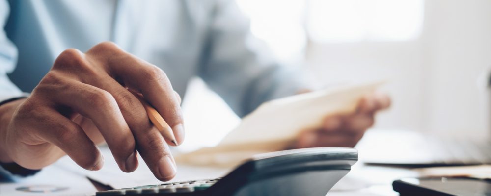 male accountant banker use calculator